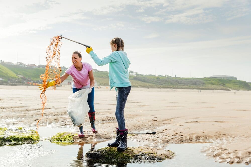 two people doing a beach clean